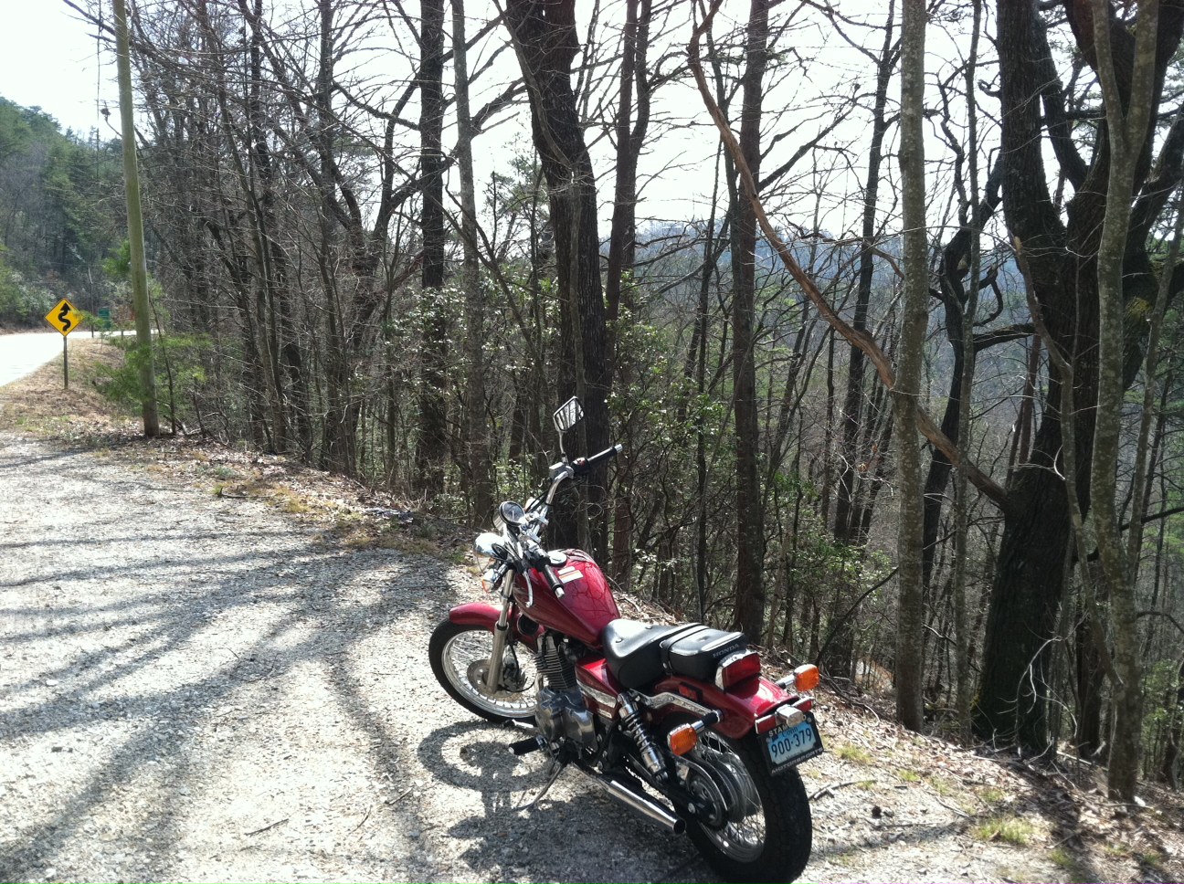 2012 Candy Red Honda Rebel motorcycle parked along a curvy road in north Georgia