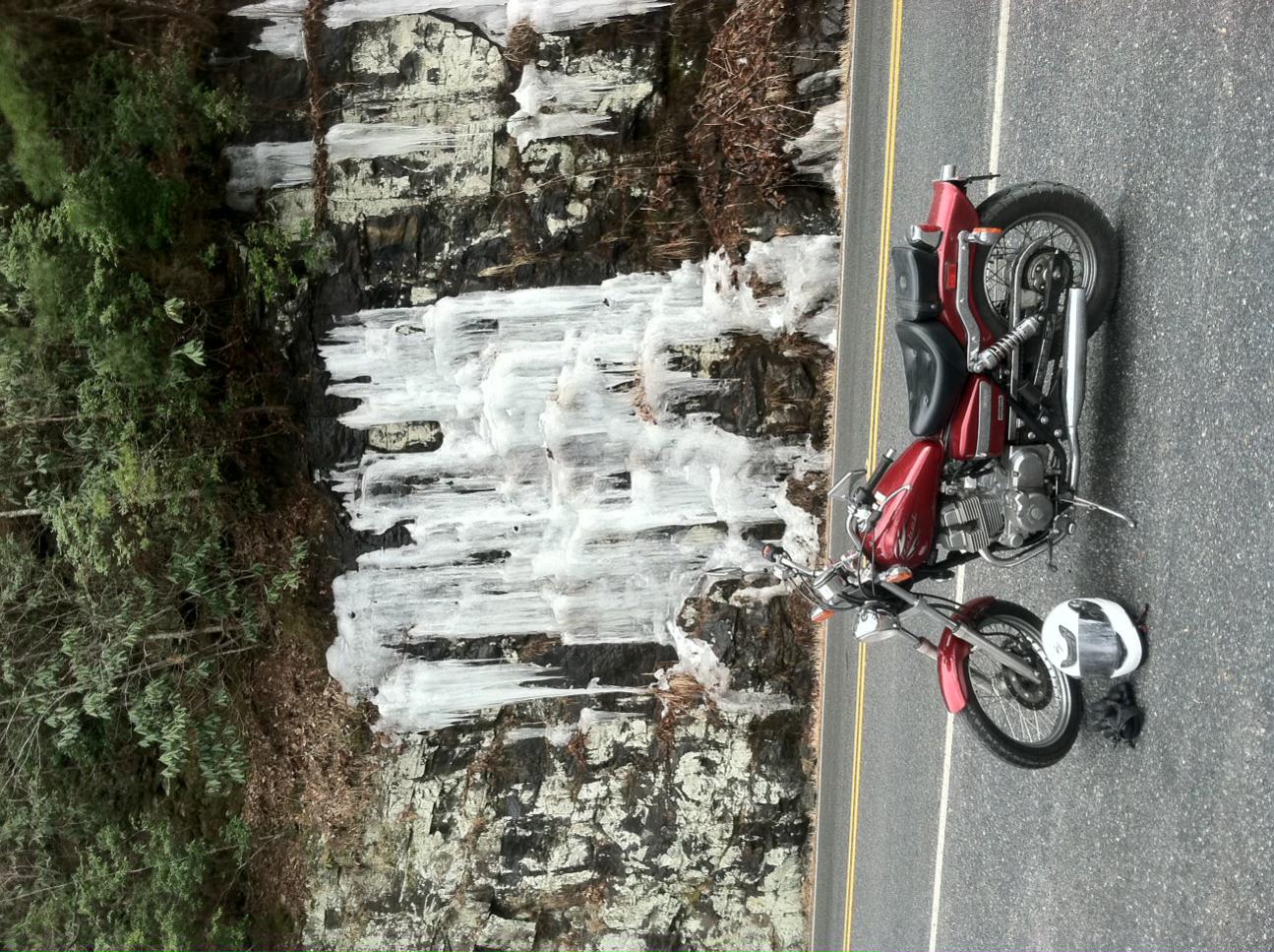 Candy Red 2012 Honda Rebel motorcycle with view of icy rock face in north Georgia